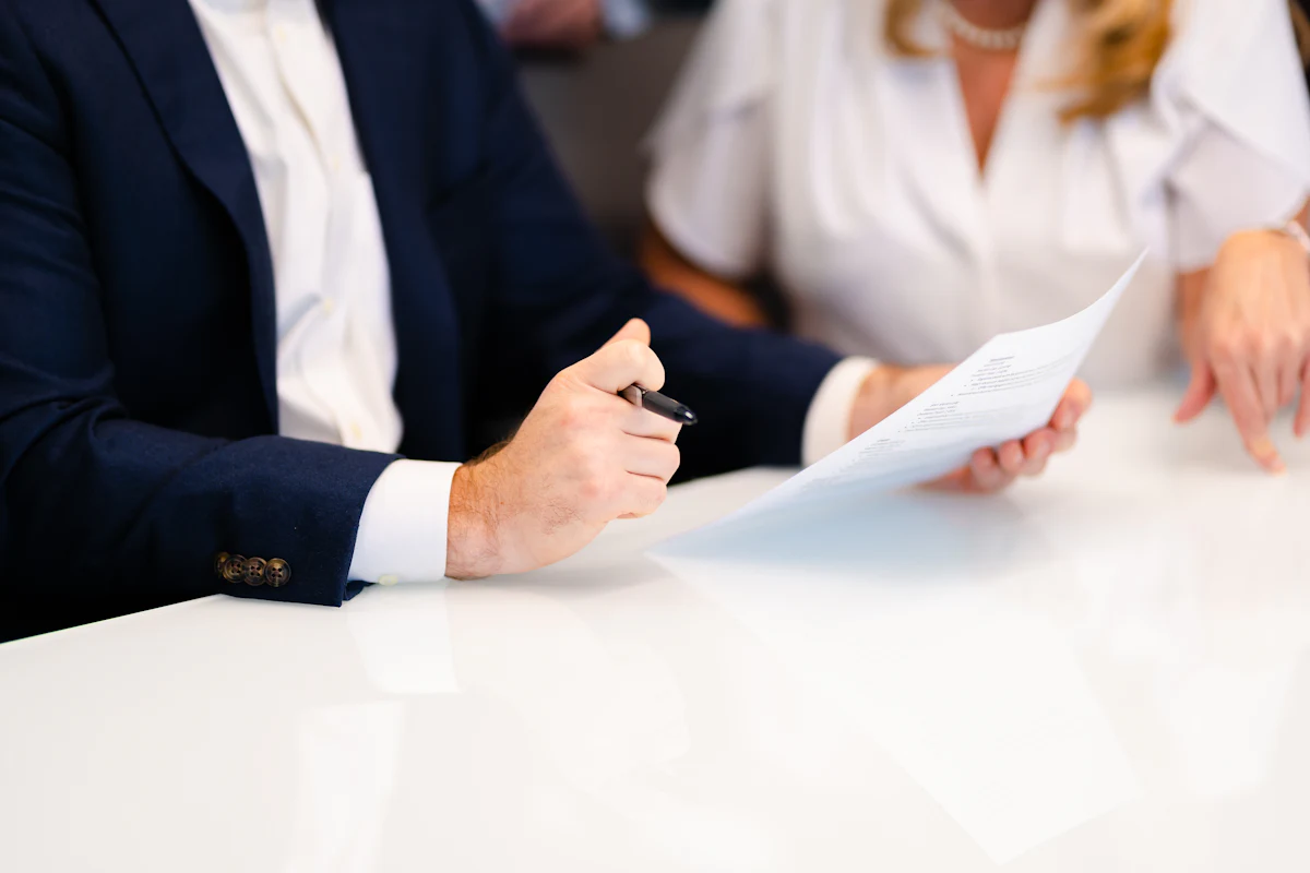 Attorney meeting with a client at a table to review documents